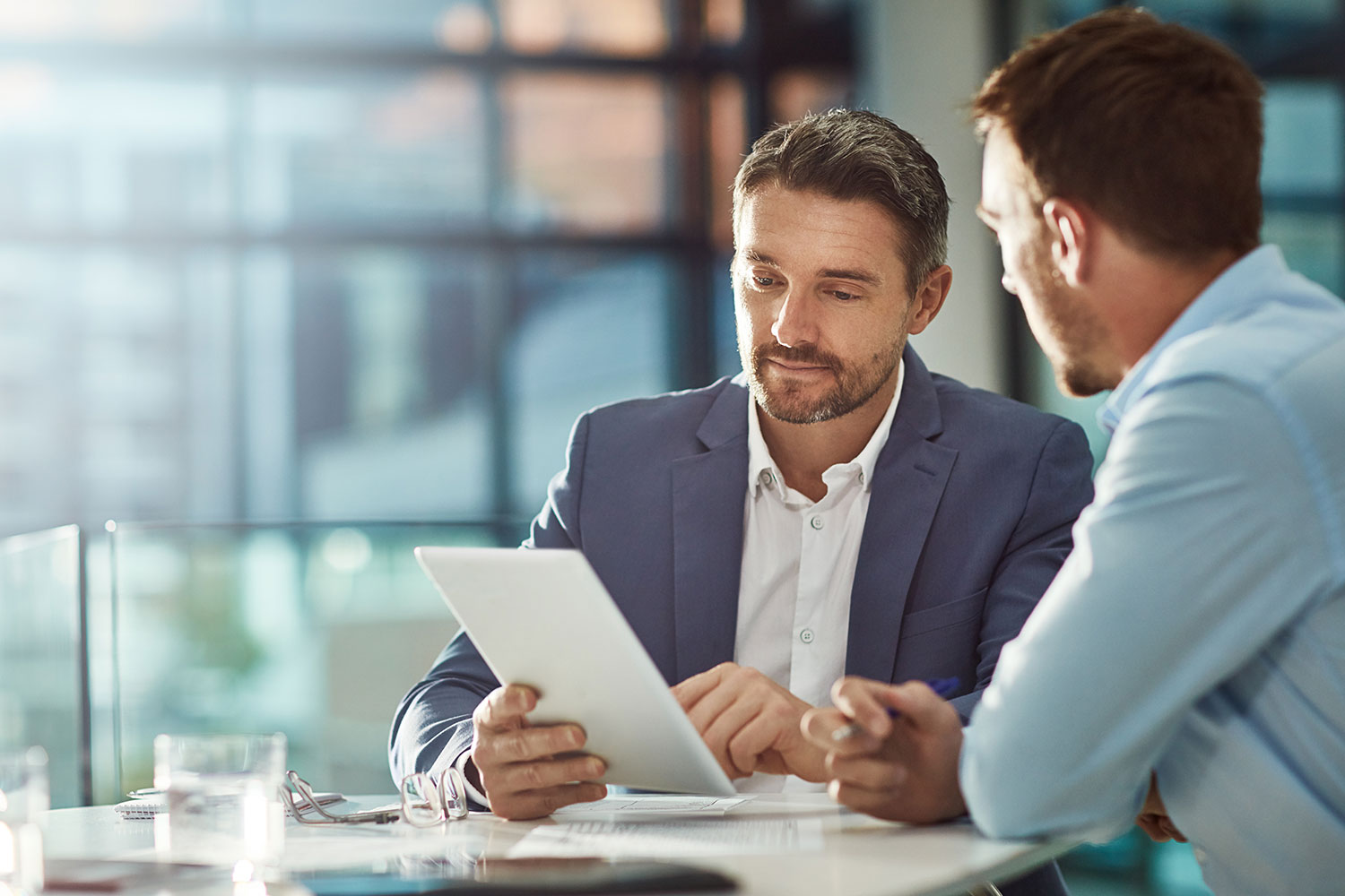 sales leader meeting coaching sales rep at office table 